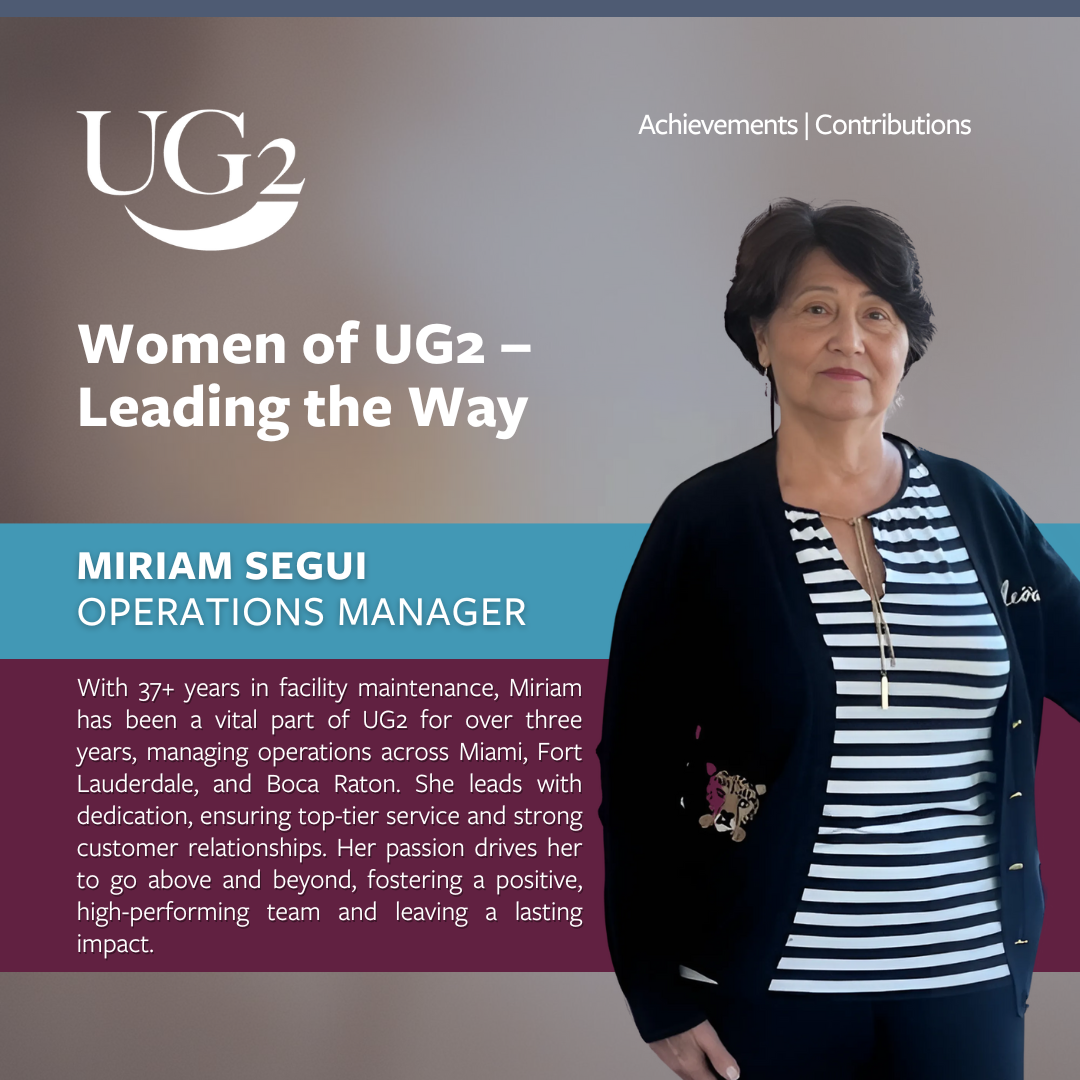 Miriam Segui, Operations Manager at UG2, stands next to a description of her 37+ years leading the way in facility maintenance and leadership across Miami, Fort Lauderdale, and Boca Raton.