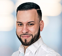 Headshot of a bearded man in a white collared shirt from the Tri-State Area.